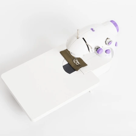 White sewing machine with a white background