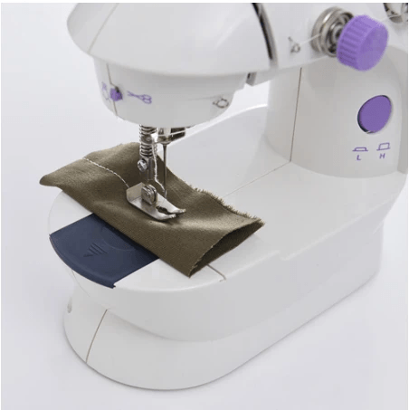 White sewing machine with brown fabric on a white background