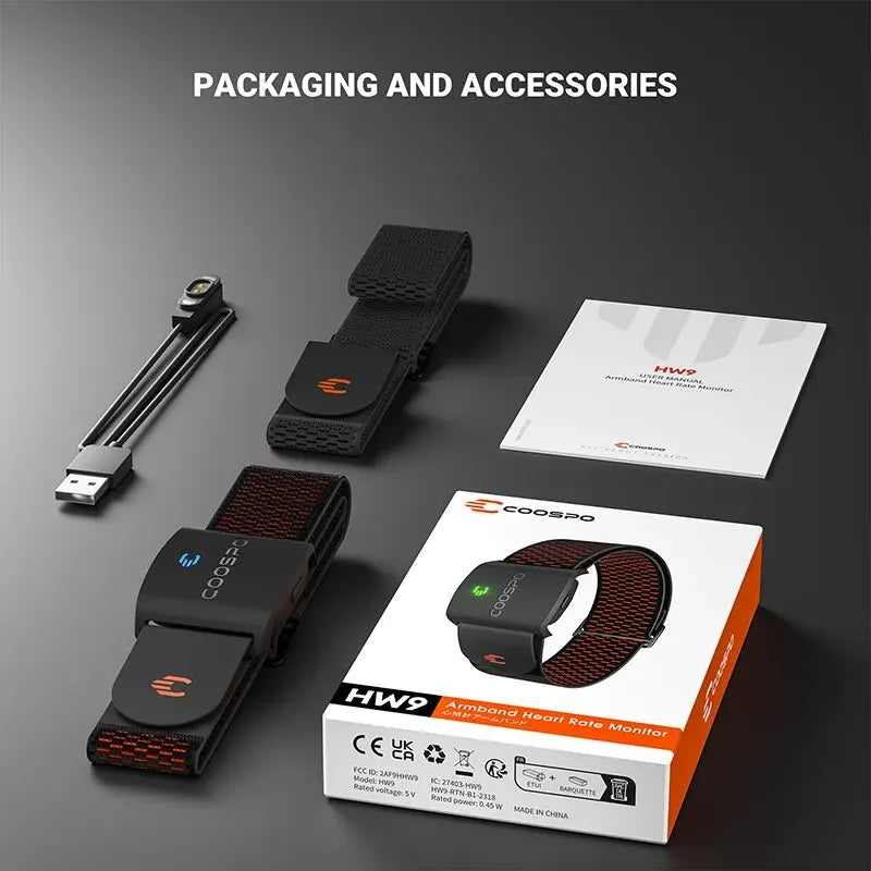 Packaging and accessories of a health monitor including straps, USB cable, and user manual on a dark background.